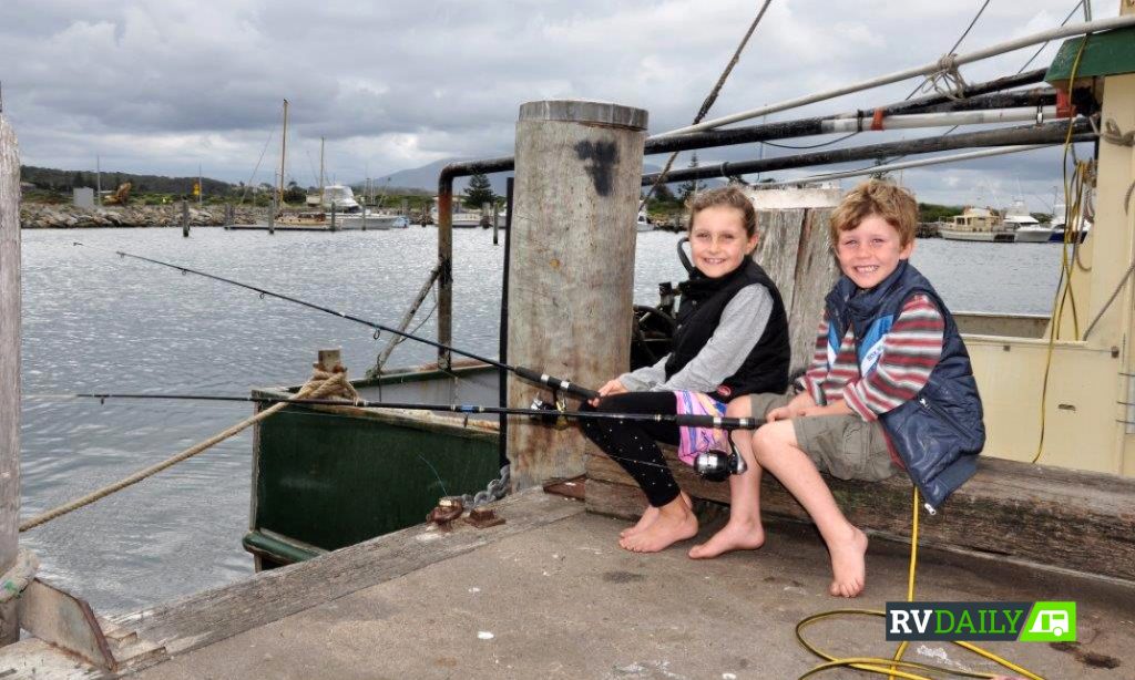 kids fishing on a pier