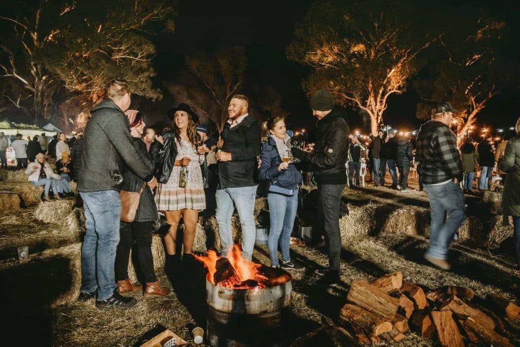 People enjoying wine at the Mudgeeque event.