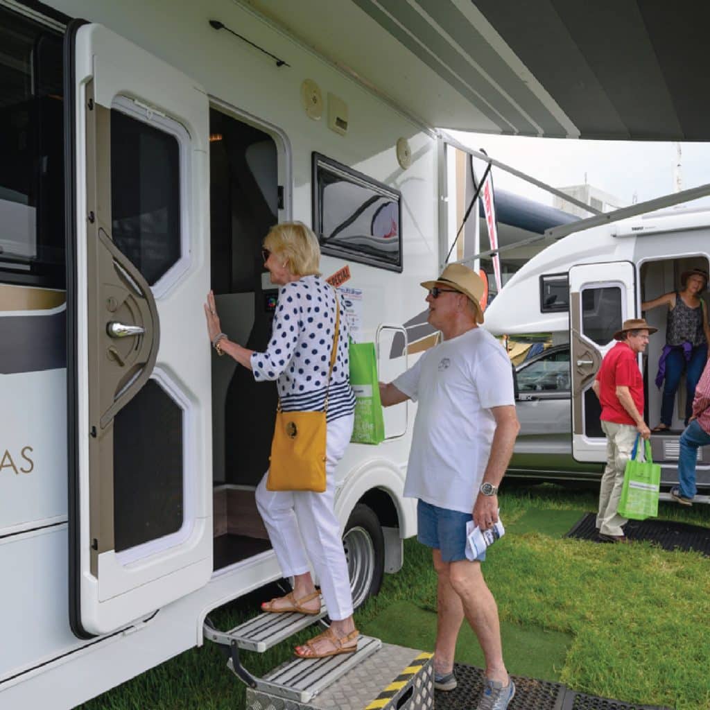 A couple checking out the inside of a caravan