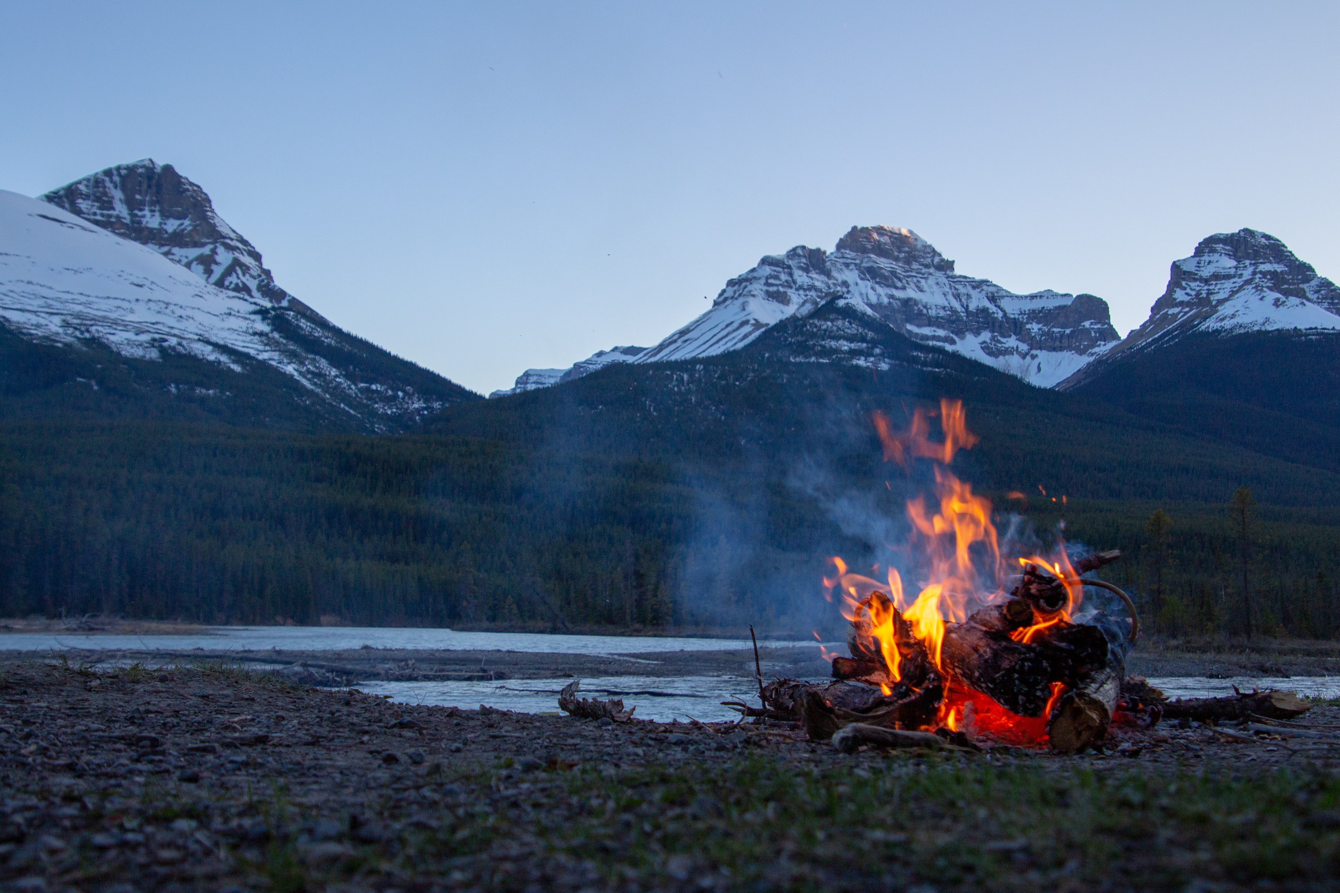campfire surrounded by mountains