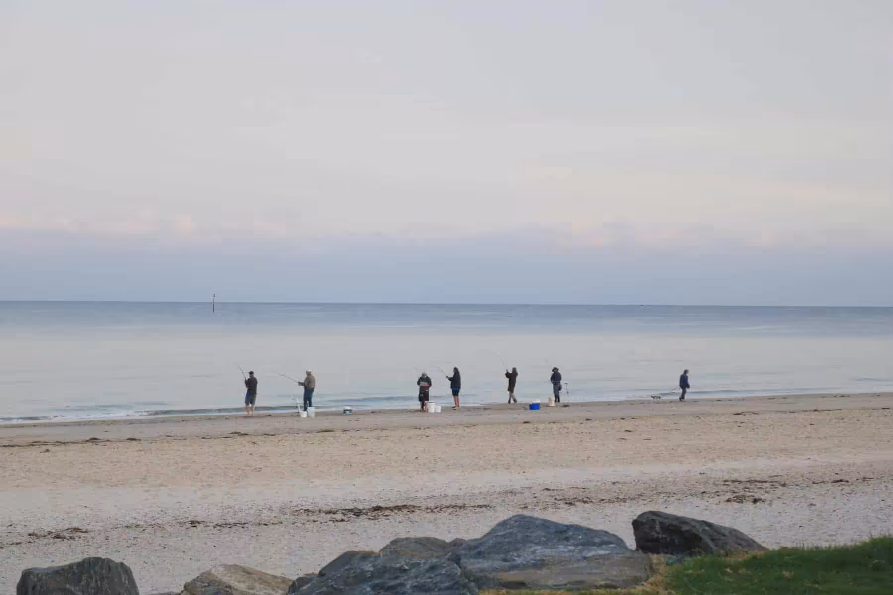 Group of people fishing in South Australia on Seacliff Beach