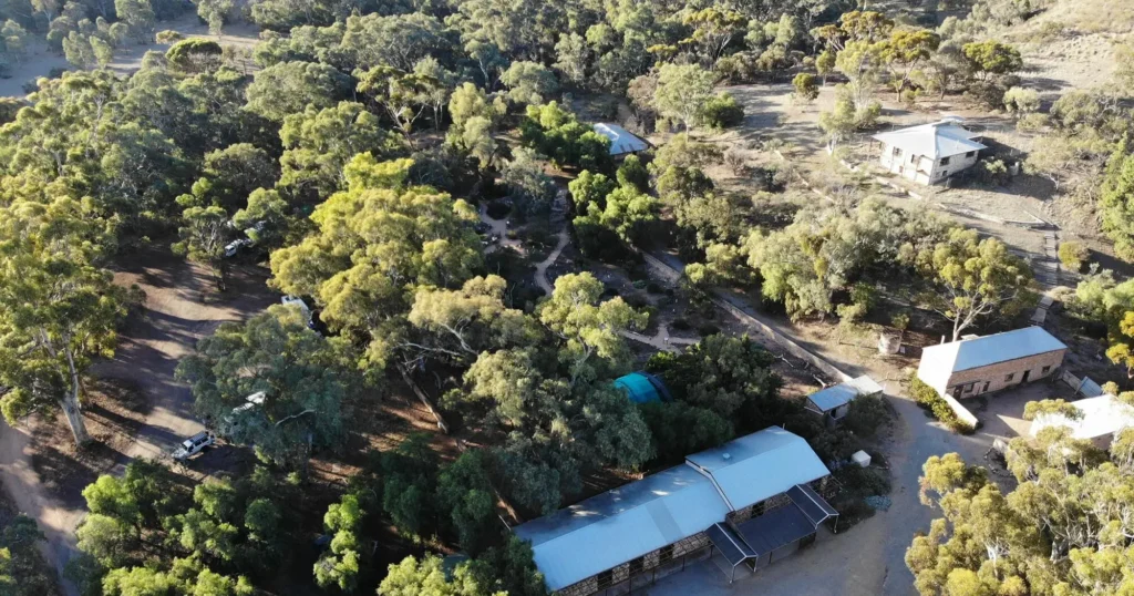 Caravan solar panels in the shade: A caravan parked under trees where solar production is limited