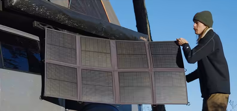 Portable solar panels: A Renogy folding solar mat angled toward the sun on the ground