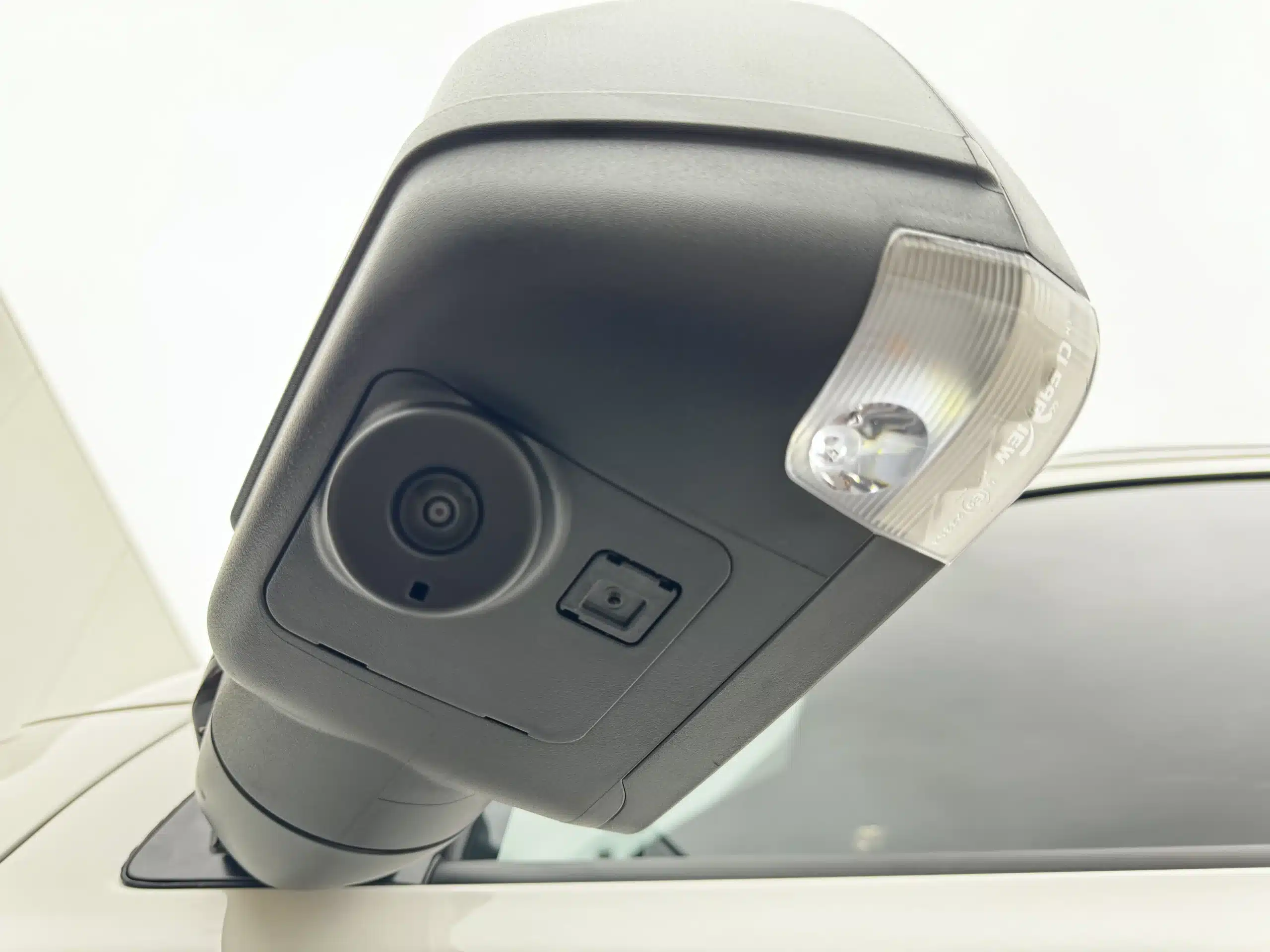 360 Camera Integration: Close up of a camera lens integrated into the bottom of a towing mirror housing