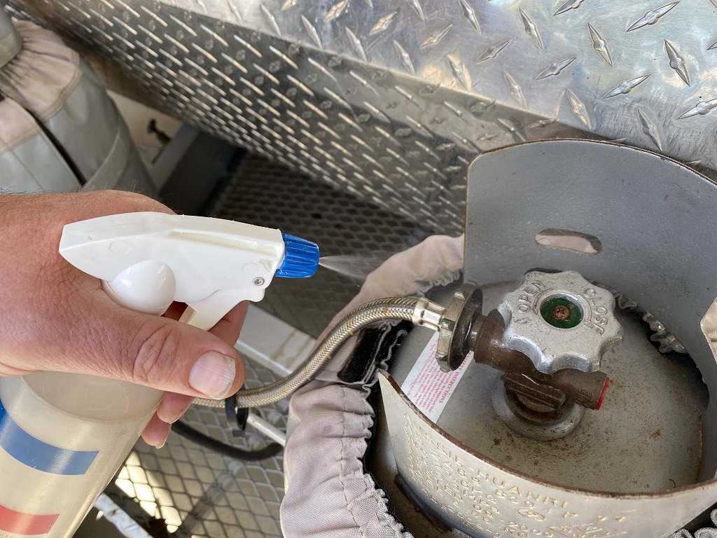 Using a soap solution to test for LPG gas leaks